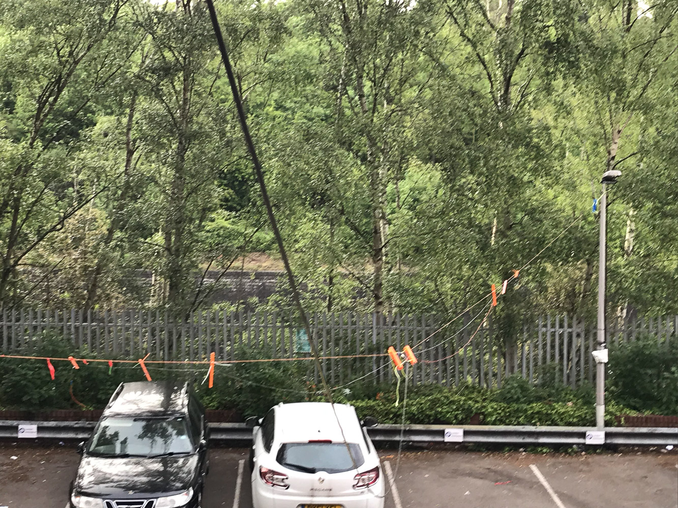 The antenna, strung between the building (via an open window) and a fibreglass pole tied to the lamp post